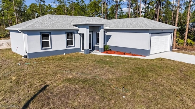 view of front of property with a garage and a front yard