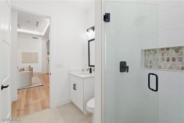 bathroom with vanity, hardwood / wood-style flooring, a shower with shower door, and toilet