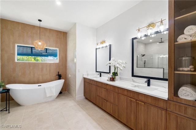 bathroom with independent shower and bath, vanity, and tile patterned floors