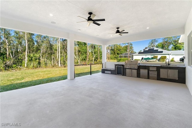 view of patio / terrace with ceiling fan, area for grilling, and sink