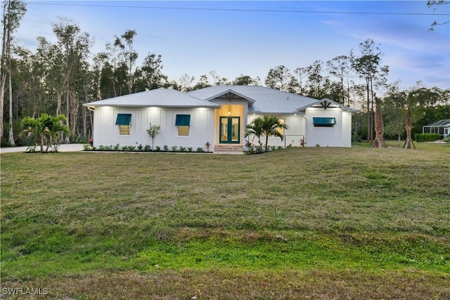 view of front of house with a front yard and french doors