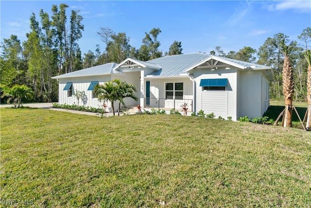 ranch-style house featuring a front yard and metal roof