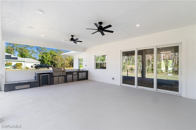 view of patio with exterior kitchen, grilling area, and ceiling fan