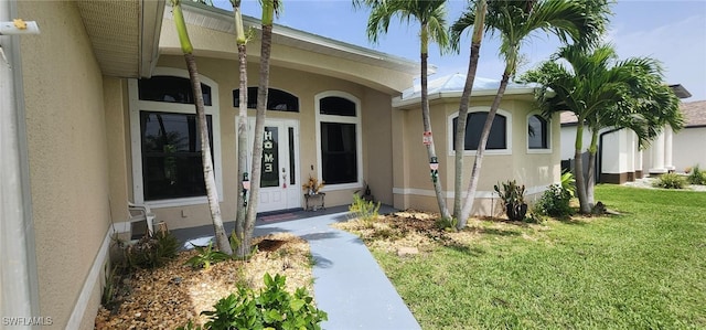 doorway to property with a yard