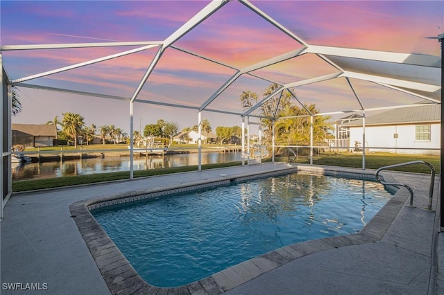 pool at dusk with a lanai, a patio, and a water view