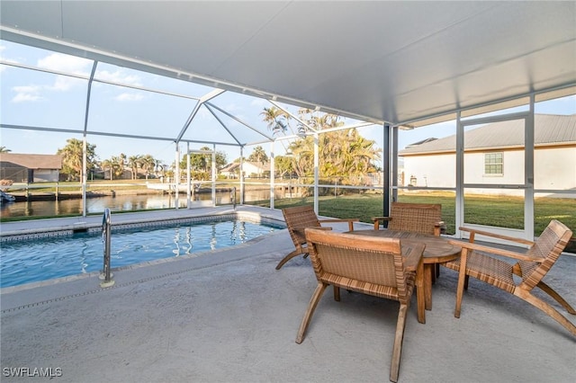 view of pool featuring a water view, a patio area, and glass enclosure