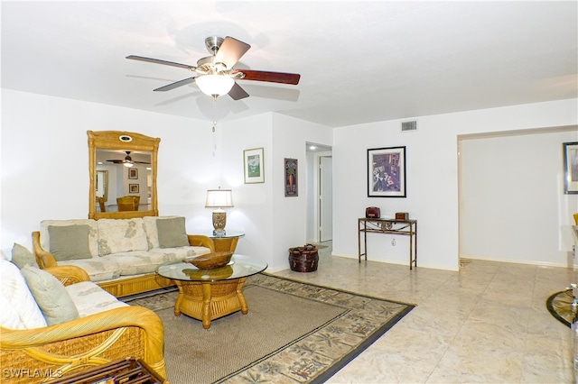 living room featuring baseboards, visible vents, and ceiling fan