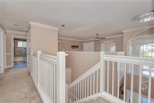 hallway with ornamental molding and light carpet