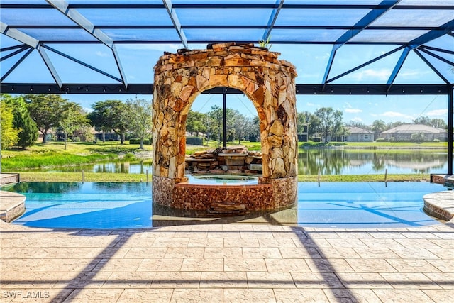 view of swimming pool with a water view, an in ground hot tub, a lanai, and a patio area