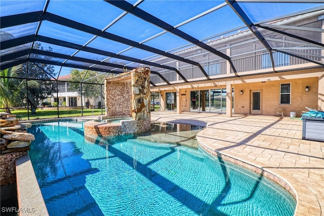 view of swimming pool featuring an in ground hot tub, a patio area, and glass enclosure