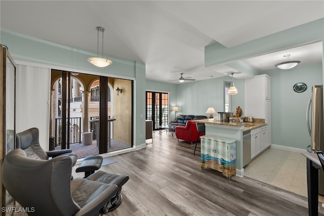 living room featuring ceiling fan and light hardwood / wood-style floors