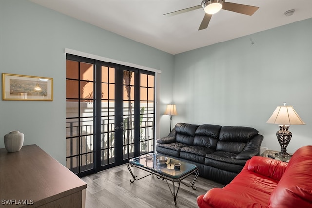 living room featuring light hardwood / wood-style floors, french doors, and ceiling fan