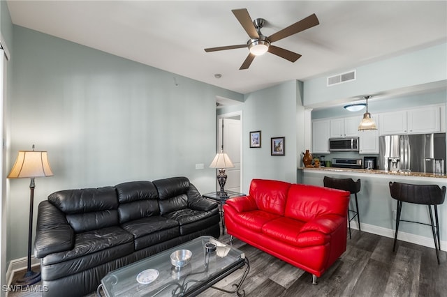 living room with ceiling fan, dark wood finished floors, baseboards, and visible vents