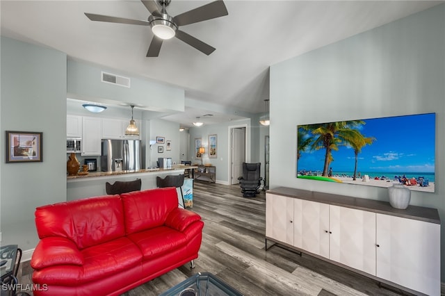 living room with a ceiling fan, baseboards, visible vents, and dark wood-style flooring