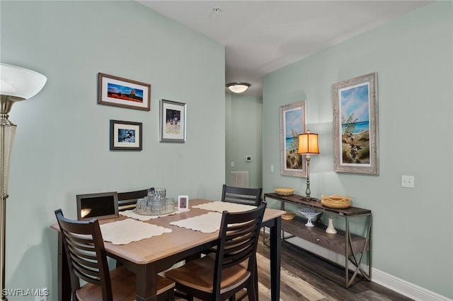 dining area with baseboards and wood finished floors