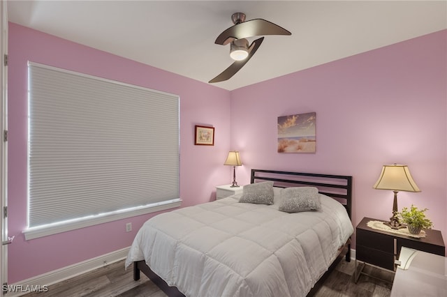 bedroom featuring dark wood-type flooring and ceiling fan