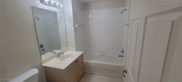 full bathroom featuring tile patterned floors, vanity, toilet, and tiled shower / bath combo