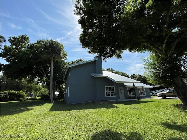 view of side of home featuring a yard