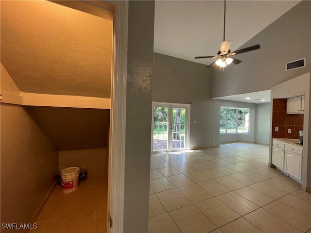 200 Ridgewood Ave, Clewiston, FL 33440 - interior space with light tile patterned floors, ceiling fan, high vaulted ceiling, and baseboards
