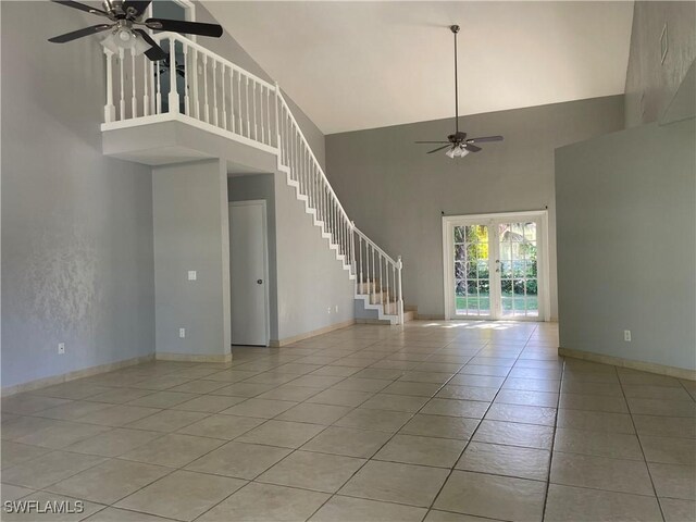 200 Ridgewood Ave, Clewiston, FL 33440 - unfurnished living room with a ceiling fan, high vaulted ceiling, french doors, light tile patterned floors, and stairs