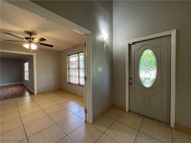 200 Ridgewood Ave, Clewiston, FL 33440 - foyer entrance with plenty of natural light, light tile patterned floors, baseboards, and a textured wall