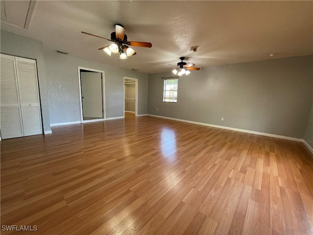 unfurnished bedroom featuring ceiling fan and light wood-type flooring