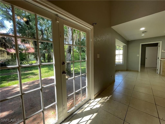 doorway to outside featuring french doors and light tile patterned floors