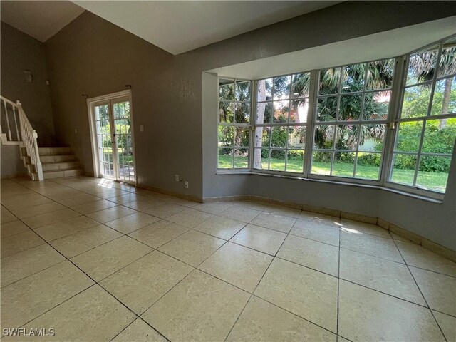 200 Ridgewood Ave, Clewiston, FL 33440 - spare room featuring light tile patterned flooring, stairs, and baseboards