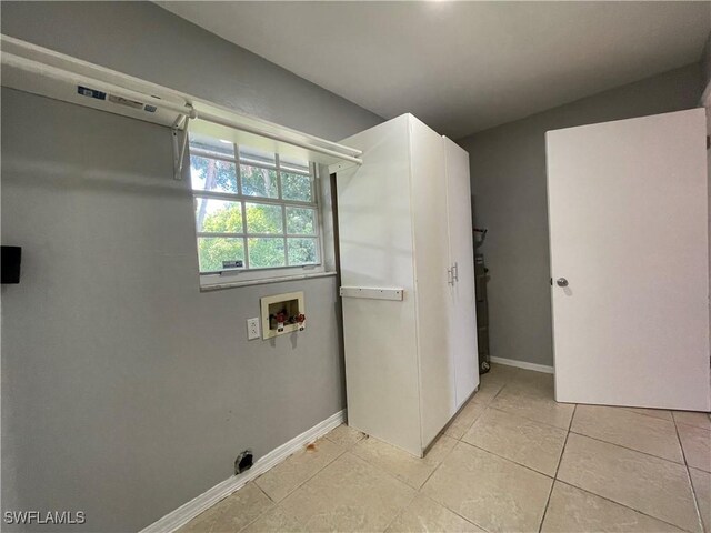 200 Ridgewood Ave, Clewiston, FL 33440 - washroom with hookup for a washing machine, light tile patterned floors, and baseboards