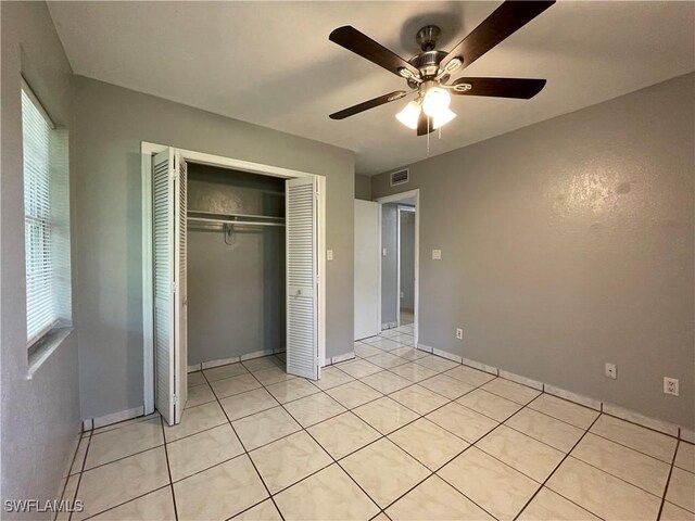 200 Ridgewood Ave, Clewiston, FL 33440 - unfurnished bedroom featuring a closet, light tile patterned flooring, and a ceiling fan