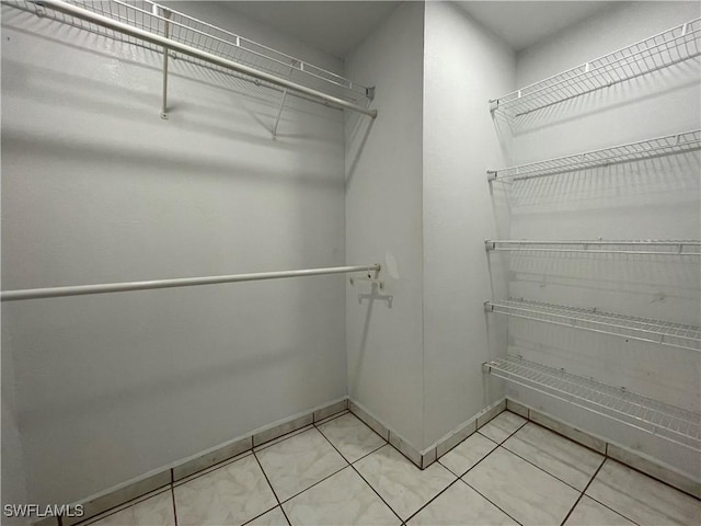 walk in closet featuring tile patterned flooring