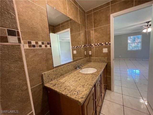 bathroom featuring tile patterned flooring, vanity, tile walls, and ceiling fan