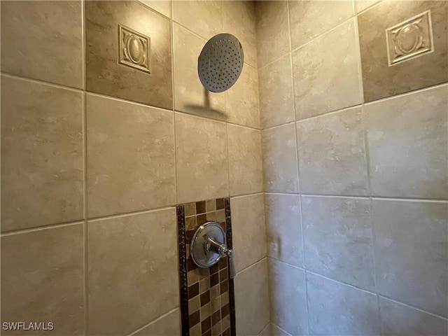 interior details featuring a tile shower