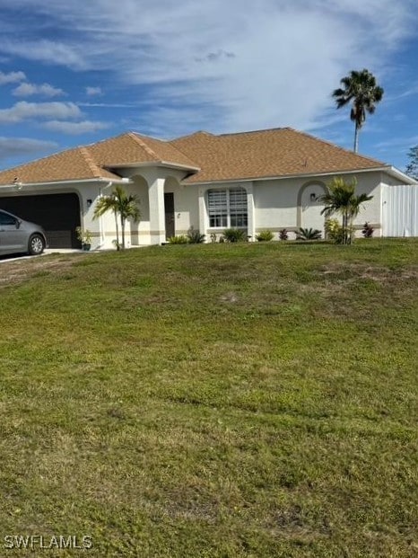 view of front of house with a garage and a front yard