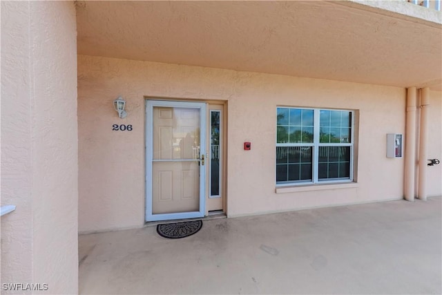 doorway to property with a patio