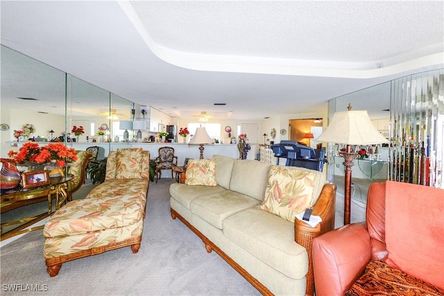 living room featuring light carpet and a textured ceiling