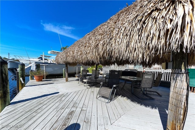 wooden terrace featuring a gazebo and a water view