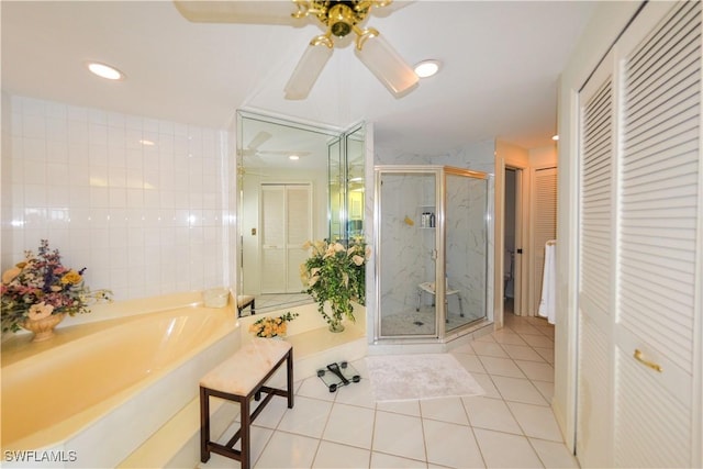 bathroom with ceiling fan, tile patterned floors, independent shower and bath, and tile walls