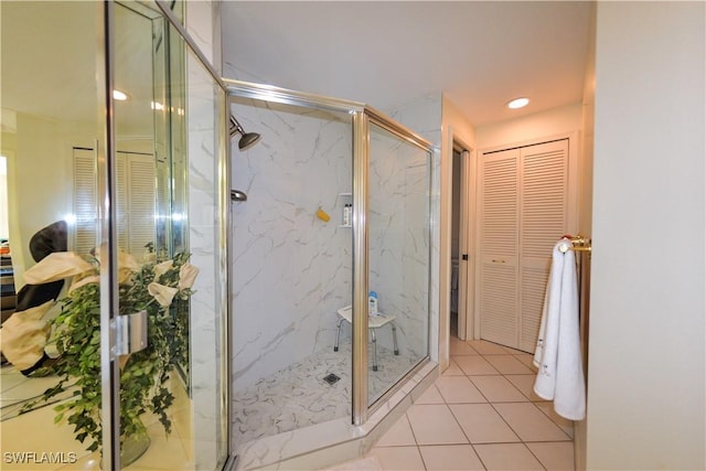 bathroom with tile patterned floors and a shower with door