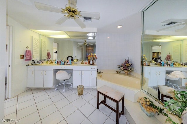 bathroom featuring ceiling fan, tile patterned floors, a bathing tub, and vanity