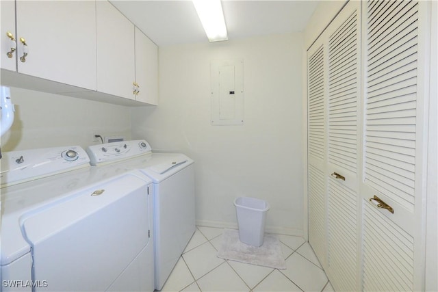 clothes washing area with cabinets, washer and dryer, light tile patterned floors, and electric panel