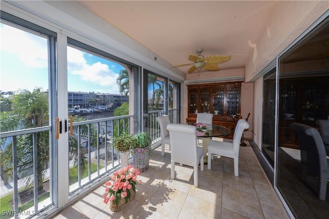 sunroom featuring ceiling fan