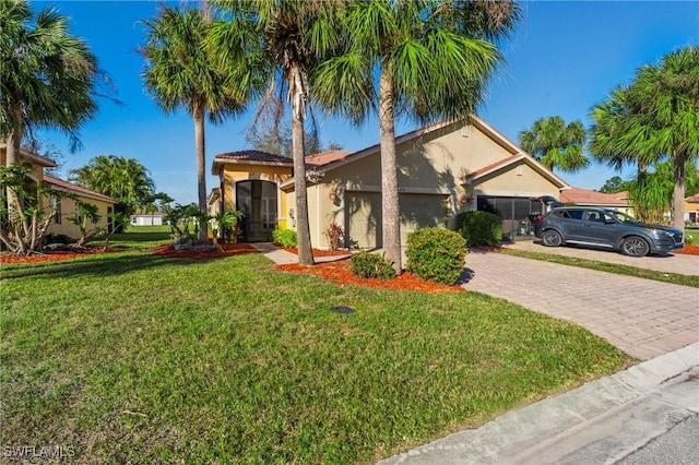 mediterranean / spanish home with a garage and a front yard