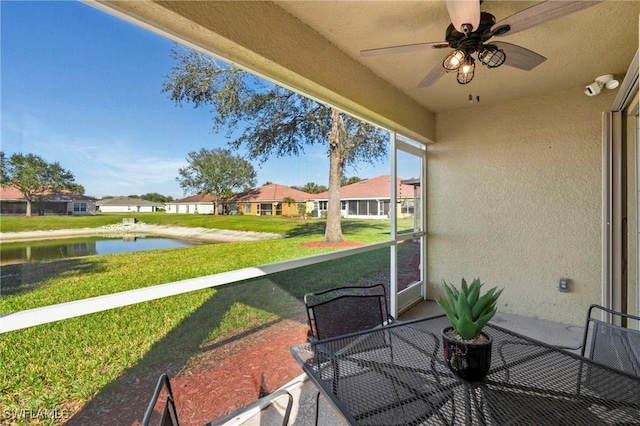 exterior space featuring a water view and ceiling fan