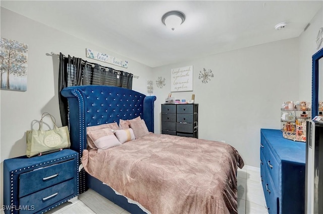 bedroom with light tile patterned floors