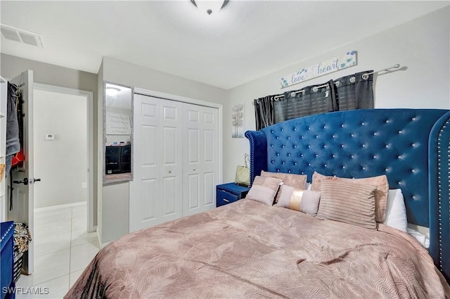 bedroom featuring a closet and light tile patterned floors