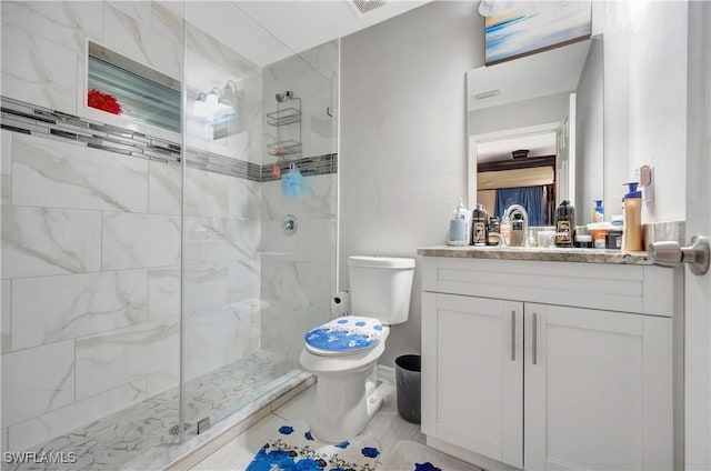 bathroom with vanity, an enclosed shower, and toilet