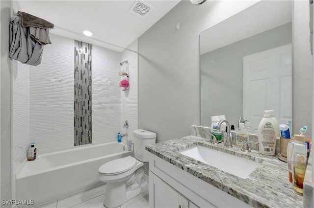 full bathroom with vanity, toilet, and tiled shower / bath combo