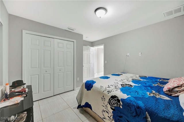 tiled bedroom featuring a closet