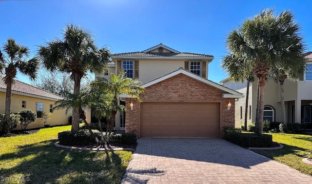 view of front of house with a garage and a front lawn